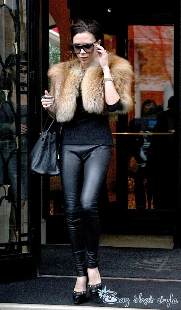  Victoria Beckham is virtually smiling with her Birkin